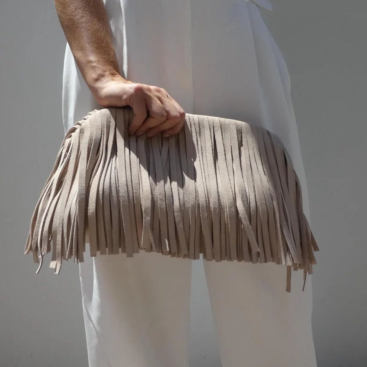 Handmade suede tasselled framed clutch
